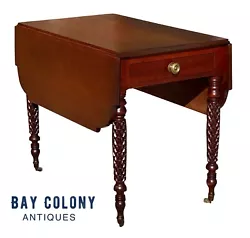 The table has a single drawer with an embossed brass pull, shaped leaves, and finely carved legs. The table retains its...