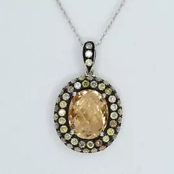 10 x 8 mm oval light citrine. Diamonds are accented with black rhodium finish. Surrounded by yellow / champagne colored...
