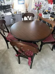 Bring a touch of elegance to your dining room with this beautiful round wooden dining table and four matching chairs....