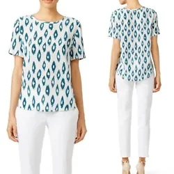 It is in an allover ikat print in blue and white colors. It features; a round neckline, short sleeves and a straight...