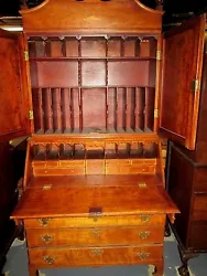 Sits on a bold, tall bracket dovetailed base. The original crown or bonnet top shows an old repair as does the molding...