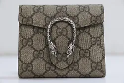 Wallet Beige Taupe. Base length: 4.25 inHeight: 3 in Width: 1.25 in Drop: 4 in. Peeling on Interior Leather.