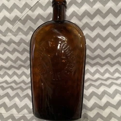 This antique whiskey bottle is a beautiful addition to any collection. The amber color gives it a unique and...