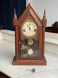 Key and pendulum present. This petite steeple clock is in working order and presents very nicely.
