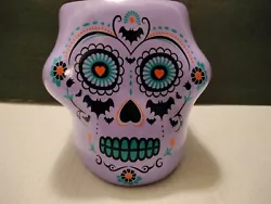 HERE IS A DAY OF THE DEAD PURPLE SKULL PLANTER.  I BELIEVE IT CERAMIC.  MEASURING 6X6