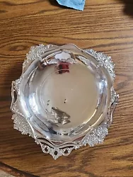 This is a nice silver serving dish with a handle. The handle is tight and secure. Has floral engraved edges.