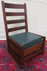 It possesses a four slat back, peg joinery and a drop in seat box. The seat was redone in a very nice green leather....
