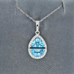 2 Blue topaz stones create the look of one larger gemstone. Chain is not included. 1/10 ctw Diamonds. 9.3 mm wide.