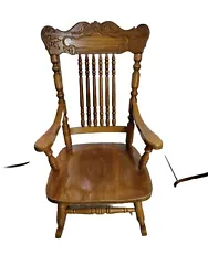 This vintage rocking chair boasts a beautiful solid oak construction with intricate carvings on the chair back.. The...