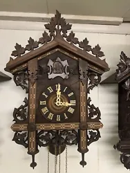 This antique cuckoo clock from the Black Forest region is a stunning addition to any clock collection. Crafted from...
