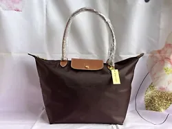 NEW Longchamp Le Pliage tote bag. Nylon; trims: leather. Top zip closure. Interior slip pocket.