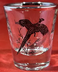 This shot glass is a beautiful souvenir for collectors and those who appreciate unique barware. The design features a...