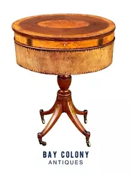 The table has a Mahogany & Satinwood top with hand tooled leather around the body. The very center of the top has a...