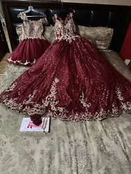 This stunning quinceanera dress in burgundy and gold is fit for a princess. The dress features a long tulle skirt with...
