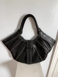 The bag features lining made of fabric, black hardware, and a black leather handle for added comfort. Its exterior is...