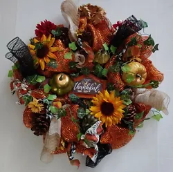 With sunflowers, asst flowers, pine cones, gourds, leaf garland, etc. Assorted flowers, sunflowers, pine cones, gourds,...