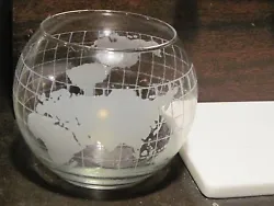 Floating candle in glass globe with wicks and floater.