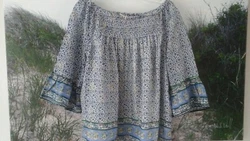 A beautiful top in excellent, gently worn condition! Very soft, 100% Rayon. Elastic neckline.