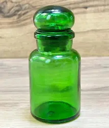 This green apothecary lidded bottle/jar was made in Belgium in the 1970s.
