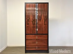 A mid century modern rosewood and black lacquered armoire dresser with chrome accents in the style of Harvey Probber...