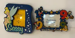 Both frames are rubbery with plastic front.  The 1999 Walt Disney World is magnet only, the Tinker bell Sassy can be...