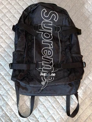 Small upper pocket with built-in key clip and zipper closure. - Padded back. - Top handle.
