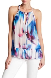 This brightly printed blouse is finished with a front tie at the neckline, allowing for adjustability. - Allover...