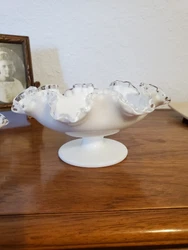 This vintage Fenton Silver Crest Milk Glass Bowl is a stunning piece of art glass. The bowl features a ruffled crimped...