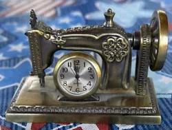 Add a touch of vintage charm to your decor with this miniature sewing machine shelf clock from MOVT. The bronze-colored...