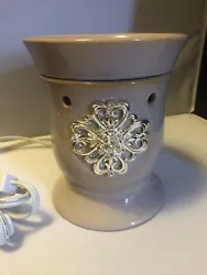 Beautiful warmer. The very pretty shines stones decorations the front. 6 inches tall 5 inches wide.