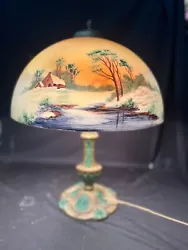 Reverse painted table lamp. The lamp stands 21