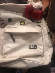This adorable Hello Kitty backpack from Loungefly is the perfect accessory for any Hello Kitty fan! The bag features a...