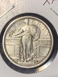 This vintage coin from the United States is a 1917 P Type 1 Standing Liberty Quarter with XF details. It features Lady...