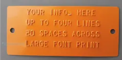 Orange Aluminum. It has 2 holes so you can mount it on to a trailer or piece of machinery for example. The text is...
