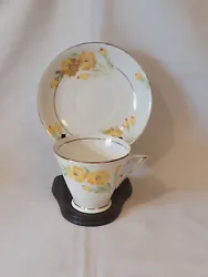This beautiful two-piece tea cup and saucer set from Phoenix China features a stunning yellow floral pattern that is...