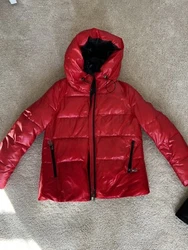 Stay warm and stylish this winter with this womens puffer jacket. The jacket features a short length and zipper closure...