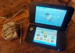 Nintendo 3DS XL Handheld System - Blue/Black. Comes with SD card 4GB, stylus and newly purchased off Amazon charger. ...
