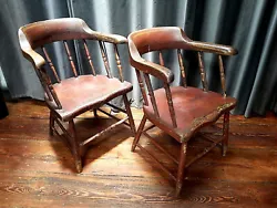 Beautiful and comfortable pair of firehouse or captains Windsor chairs. New England, the chairs built circa 1820 with...