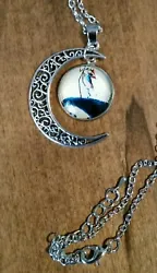 Glass pendant with silver tone crescent moon pendant with matching chain. Chain style may vary.