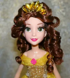 Her lush hair was curled and restyled and a hand-made tiara was added for a more glam look. Two golden roses were sewn...