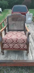 OLD VINTAGE SITTING CHAIR..SMALL HOLE IN CANE BACK AREA..2 SEAT CUSHIONS..VERY BOTTOM ONE FEELS LIKE ITS GOT COIL...