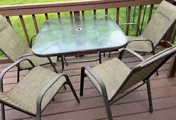No tears on chairs. Table has a center hole for an umbrella (no umbrella included).