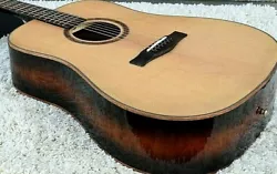 Side and back also made with Exotic LaceWood Wood. Made with a Solid Spruce Wood Top Material. Acoustic Guitar.