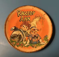 Raggedy Ann & Andy Tin Saucer - 1959. 3 inch diameter with noticeable rust.