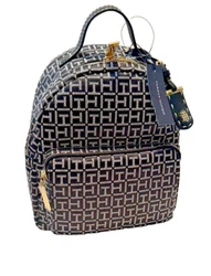 Goldtone Tommy Hilfiger logo. Navy monogram with fashion racing stripe. Navy blue lined interior with zip pocket & slip...