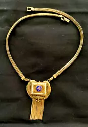 Its gold filled over brass. The chain is original 14