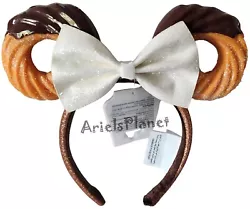Youll look sweeter than ever wearing this Minnie Mouse headband featuring chocolate-dipped churro shaped ears and a...