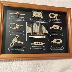 Add a touch of nautical charm to your home décor with this beautiful 14-inch wood-framed shadow box. The frame...