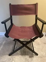 Vintage Telescope Directors Chair. Burgundy seat and back with black wooden frame. Chair folds for easy transportation...