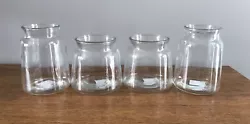 Decorative glass jar set. Set of four decorative glass jars, new and in the box. The taller jars are 7” tall and 5...